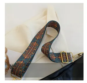 Dettaglio della tracolla boho vintage con ricamo geometrico e fibbia in oro