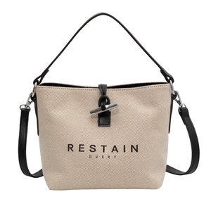 Premium canvas bucket bag in khaki and black leather with silver horn buckle closure