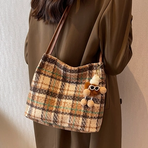 Classic plaid tweed tote bag with leather straps and plush charm for autumn fashion