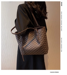 Detail of coffee brown tote bag featuring full NK letter pattern and slim shoulder strap