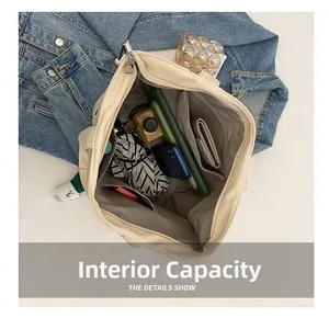 Large capacity canvas tote bag showing interior pockets with umbrella and tablet