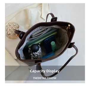 Interior view of large capacity tote bag showing umbrella, wallet and essentials