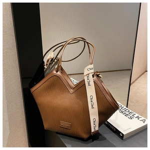 Detail of coffee brown V-cut tote bag with vertical stripes and brand strap