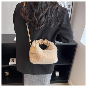 Detail of beige faux fur crossbody bag with knot handle and slim leather strap