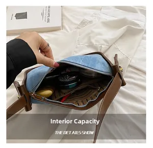 Internal capacity of denim and leather shoulder bag with zipper pocket and cosmetics