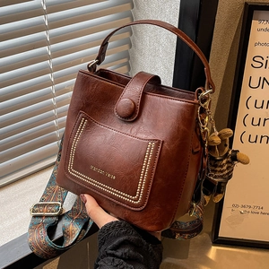 Retro reddish brown PU bucket bag with patterned strap and cute bear charm pendant