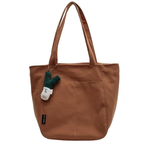 Brown canvas tote bag with large capacity, dual handles, and plush onion charm