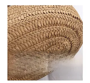 Macro shot of the intricate brown woven texture on a large capacity straw tote bag
