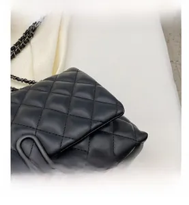 Detailed close-up of premium quilted black chain bag with elegant rhombic stitching