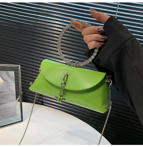 Neon green leather mini bag featuring a rhinestone round handle and silver chain strap