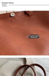 Detailed close-up of brown litchi pattern leather texture and silver magnetic buckle