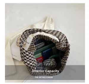 Spacious interior of houndstooth knit tote bag showing daily items like phone and umbrella