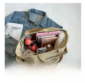 Spacious canvas tote bag interior showing capacity for tablet, umbrella and water bottle
