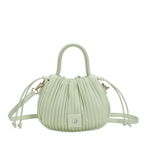 Pale green pleated bucket bag with square clasp and dual straps on white background