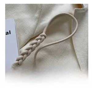 Detail of beige braided leather shoulder strap with a vintage woven pattern texture