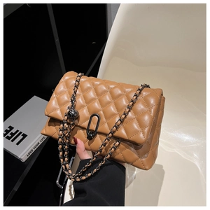 Detailed close-up of the quilted caramel leather texture and black matte metal lock