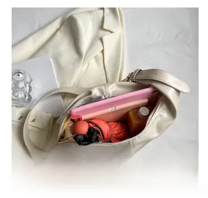 Interior view of beige leather hobo bag showing large capacity for essentials