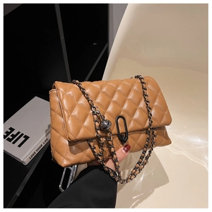 Detail of caramel quilted chain bag with classic rhombic pattern and metal ball charm