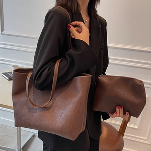 Dark brown large leather tote bag with matching wristlet set shown on model