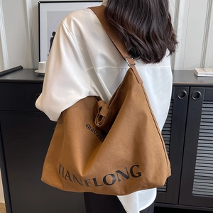 Brown canvas bucket tote bag with TIANFLONG lettering and adjustable strap for women