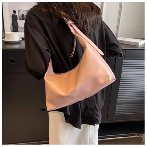 Minimalist pink hobo bag shown in a stylish home setting from a back-view perspective