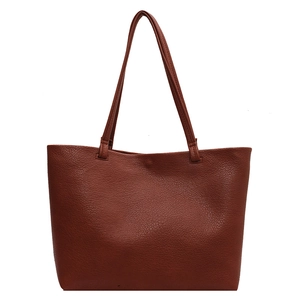 Brown lychee leather tote bag with thin double straps in a minimalist casual design