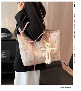 Detail of graffiti tote bag with rabbit charm and stylish pink trim accents