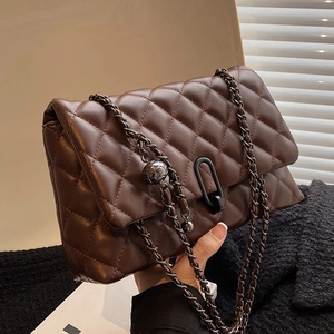 Brown quilted leather chain bag with silver sphere detail and oval buckle closure