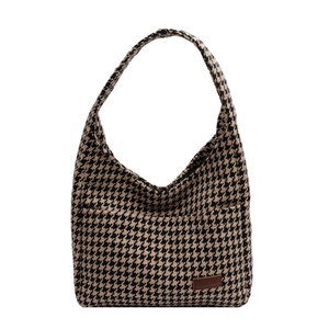Large houndstooth patterned shoulder tote bag with brown leather label on white background