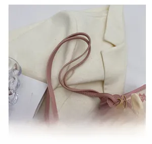Close-up of pink tote bag with cartoon bunny prints and refined stitching details