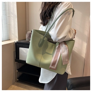 Side view of large green tote bag with printed silk scarf detail on shoulder strap