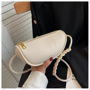 Detail of white lychee pattern crescent bag with chunky gold zipper and braided strap