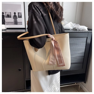 Detail of cream large tote bag featuring a pink geometric silk scarf accent for women