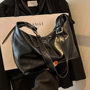 Modern black oversized hobo bag in soft leather with adjustable strap for women