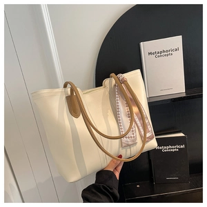 Off-white tote bag detail with brown leather straps and fashion silk scarf decor