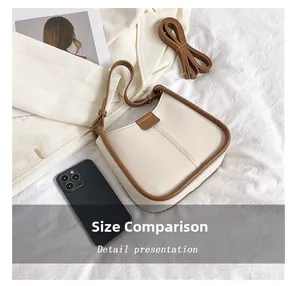 Phone size comparison showing the capacity of the cream shoulder bag with brown trim