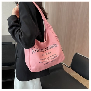 Pink canvas tote bag on model showing large capacity for daily commute and study