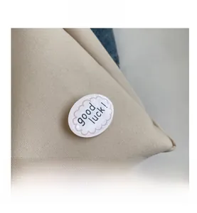 Macro view of canvas tote fabric texture featuring a decorative Good Luck badge