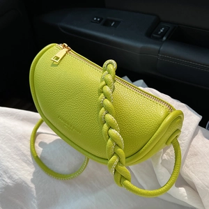 Chic grass green saddle bag with litchi texture leather and woven handle detail