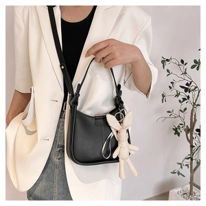 Chic black faux leather underarm bag with a cute cream knit bunny charm detail