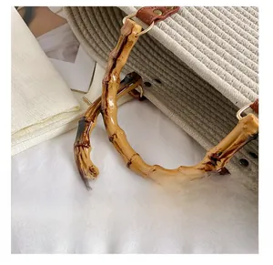 Close-up of bamboo handle and woven texture on a minimalist tote bag with metal rings