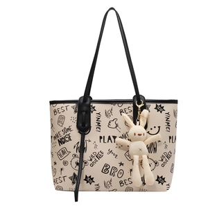 Large capacity tote bag with black graffiti print and white plush rabbit charm