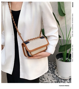Detail of retro cream canvas square bag with brown leather trim and woven strap