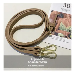 Close-up of adjustable khaki lychee grain leather shoulder strap with gold metal buckle