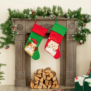 Set of two festive Christmas stockings featuring cat and dog motifs on a fireplace mantle