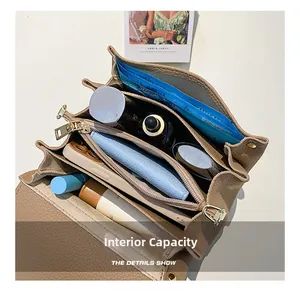 Top view of brown lychee leather bag interior showing multiple compartments and capacity