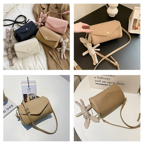Detail of square envelope crossbody bag in litchi texture PU with rabbit pendant
