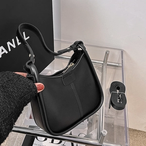 Fashionable black faux leather underarm bag with half-moon shape and shoulder strap