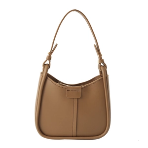 Brown leather crescent underarm bag with a vintage minimalist saddle design and stitch detail