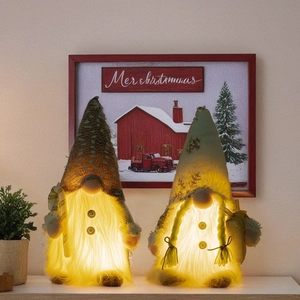 Pair of glowing Christmas gnomes with warm LED lights and sequin hats for holiday decor